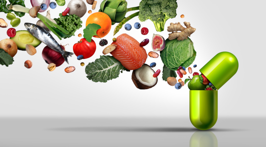 Picture with healthy food spilling out a green capsule.
