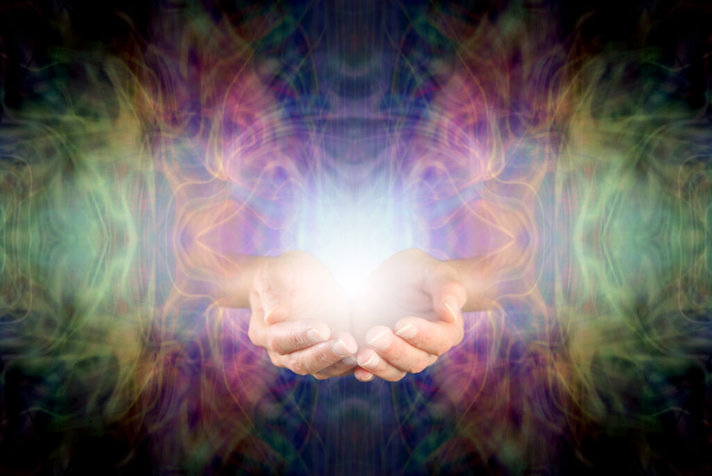 Hands with light and energy around them.