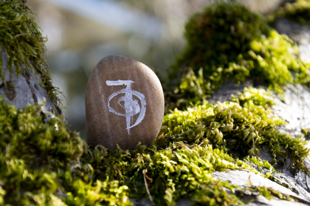 A close up image of a healing reiki symbol written on a sacred stone.