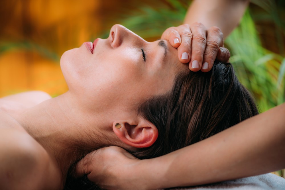 Woman receiving Reiki therapy.